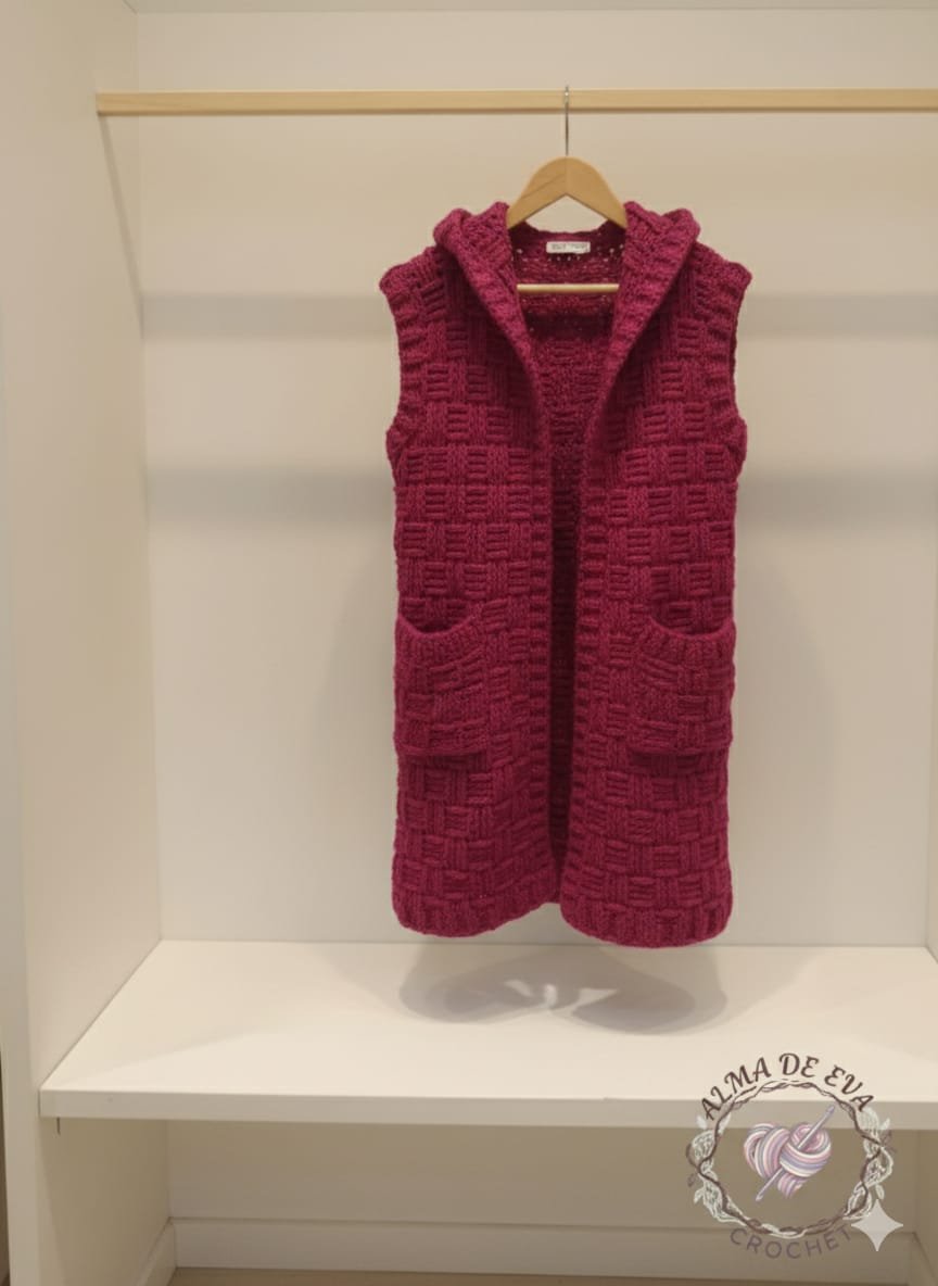 Cárdigan largo sin mangas con capucha en color rosa intenso. Hecho a mano con lana acrílica suave. Ligero, cálido y artesanal. Cárdigan largo sin mangas con capucha en color rosa intenso. Hecho a mano con lana acrílica suave. Ligero, cálido y artesanal.